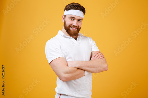 Smiling sportsman with crossed arms