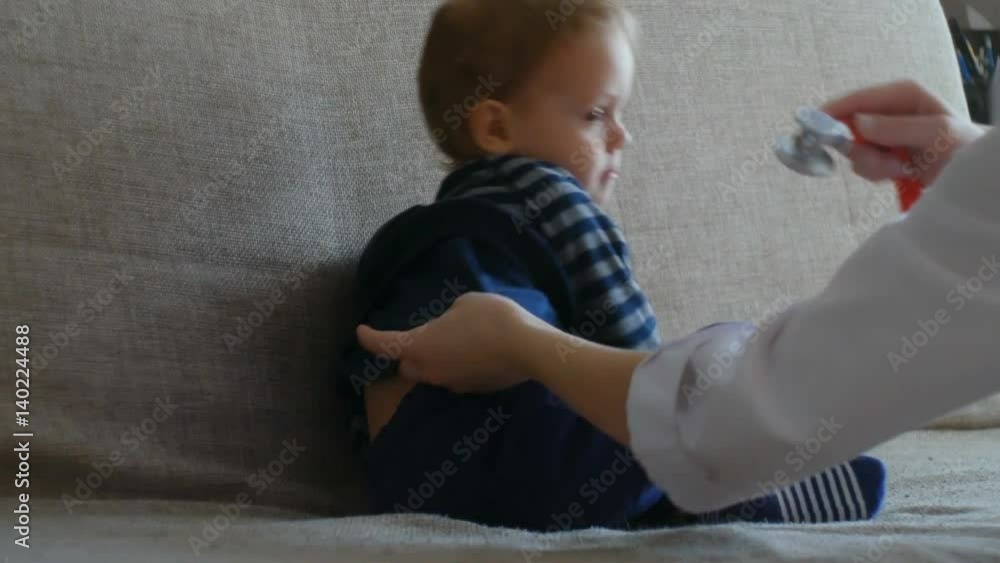 Kid doctor examing happy baby boy with stethoscope. Kid doctor examing happy baby boy with stethoscope.