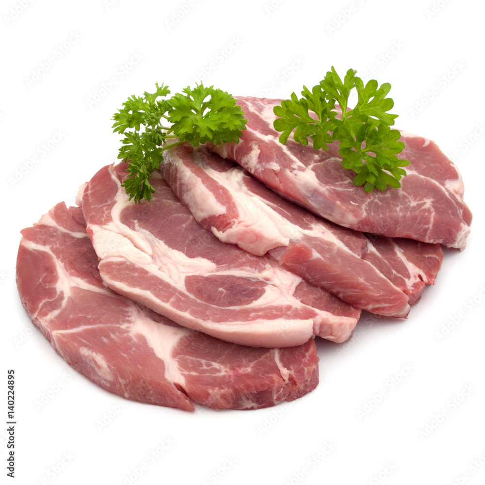 Raw pork neck chop meat with parsley herb leaves garnish isolated on white background cutout Raw pork neck chop meat with parsley herb leaves garnish isolated on white background cutout
