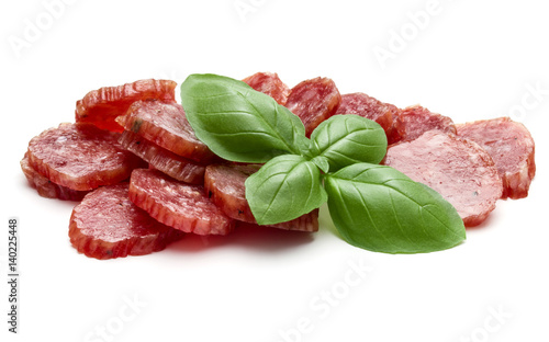 Salami smoked sausage slices and basil leaves isolated on white background cutout