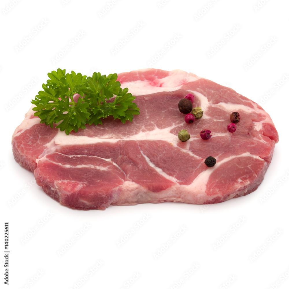 Raw pork neck chop meat with parsley herb leaves and peppercorn spices garnish isolated on white background cutout Raw pork neck chop meat with parsley herb leaves and peppercorn spices garnish isolated on white background cutout