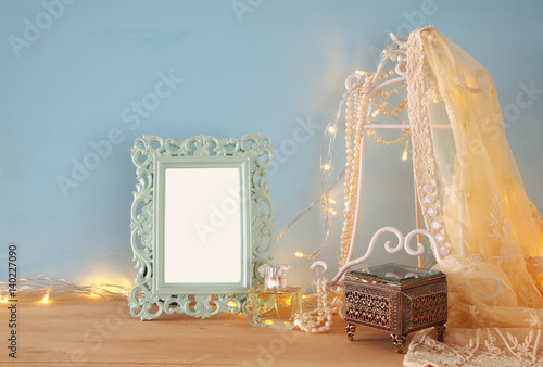 Antique blank victorian style frame on wooden table