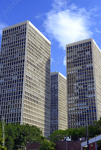 Brick and mortar buildings and skyscrapers with blue sky background