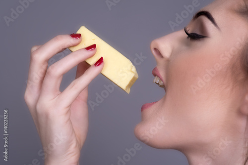 Woman eating a piece of Cheese