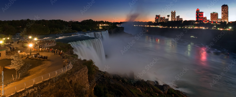 Fototapeta premium Niagara Falls lit at night show by colorful lights. American waterfall