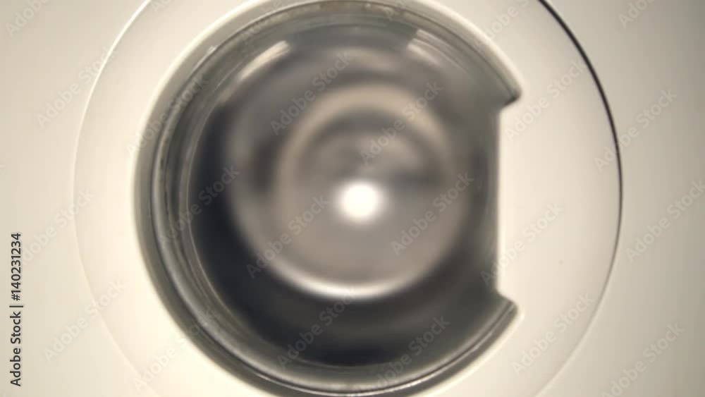 Washing machine washes colorful clothes. Copy space text. Washing machine washes colorful clothes. Copy space text.