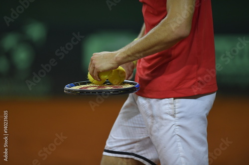 The tennis player preparing for serve photo