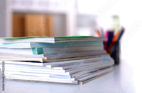 close up of stack of papers on white background