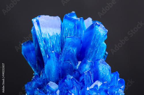 Blue salt crystal isolated on black background photo
