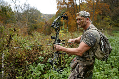 Bow hunter tracking prey