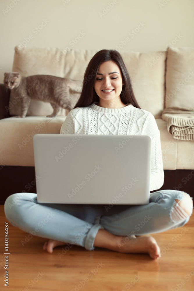 Beautiful young woman using laptop at home Beautiful young woman using laptop at home