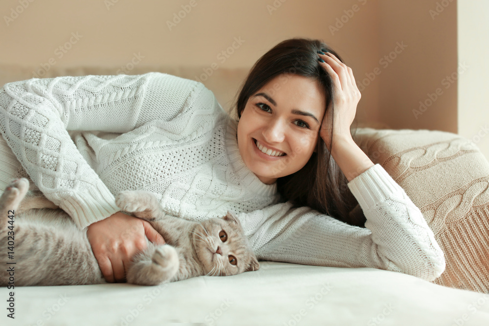 Beautiful young woman with cute cat resting at home Beautiful young woman with cute cat resting at home