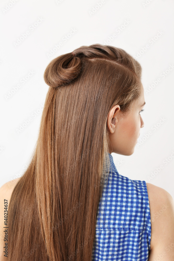 Naklejka premium Young beautiful woman with nice braid hairstyle on white background