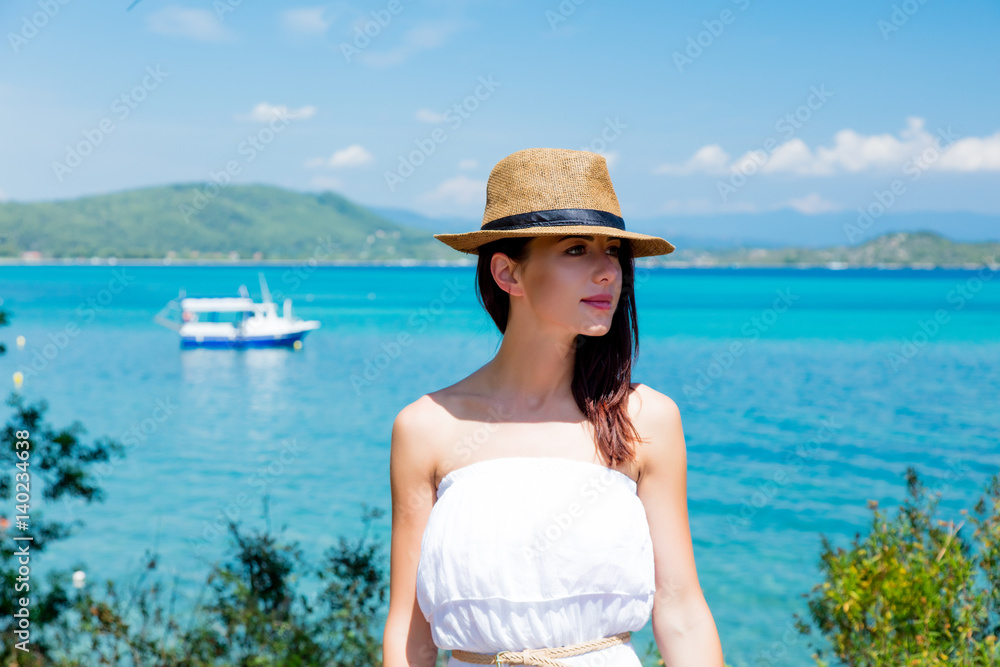 beautiful young woman standing on the wonderful sea background in greece