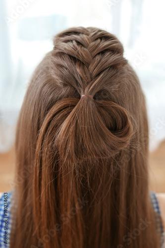 Young beautiful woman with nice braid hairstyle, closeup