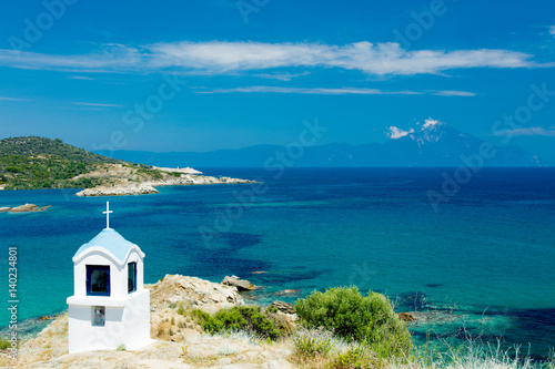 view on the wonderful small church in Greece on the sea background