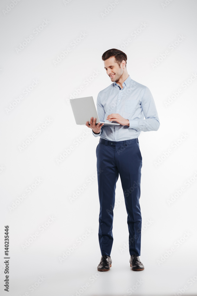 Vertical image of business man using laptop Vertical image of business man using laptop