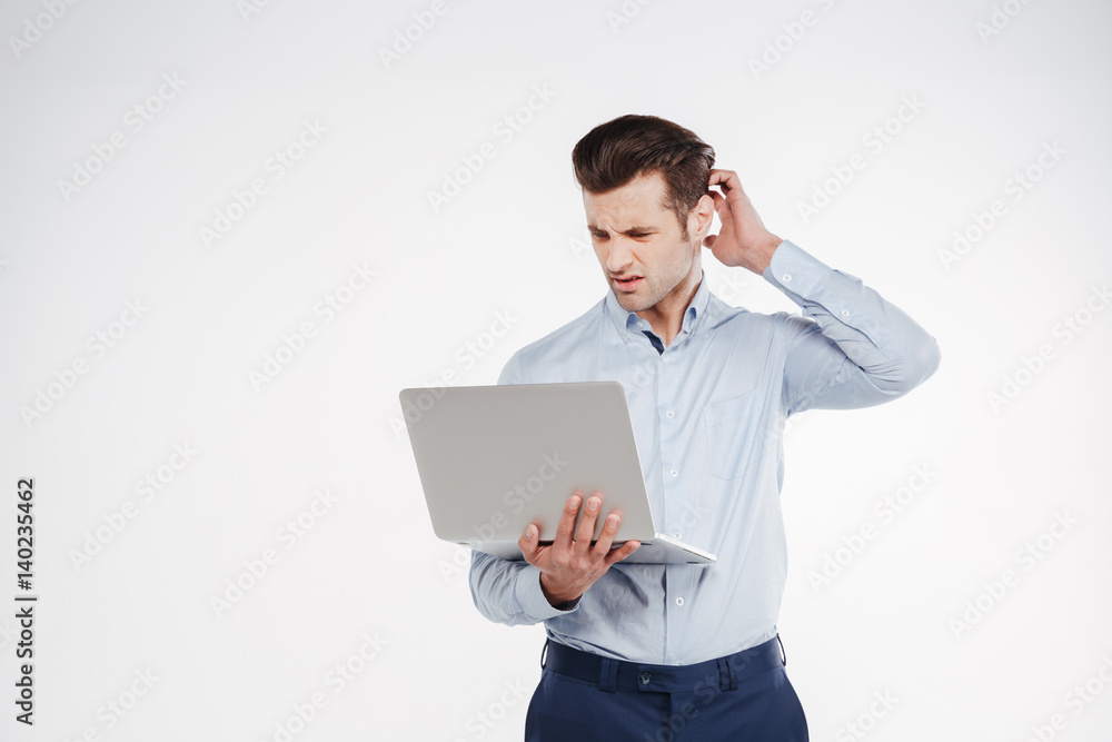 Thoughtful business man holding laptop Thoughtful business man holding laptop