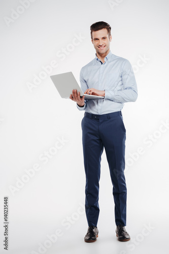 Vertical image of Smiling business man with laptop photo