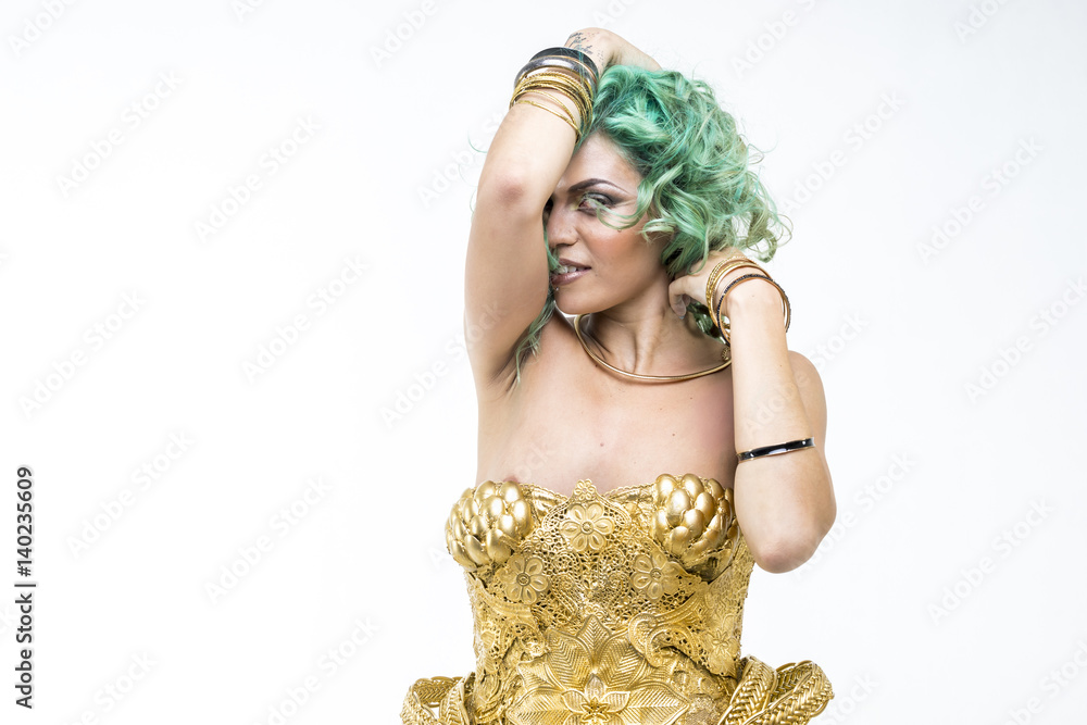 Latin woman dancing, gold dress and jewels. Young woman with her short green emerald hair