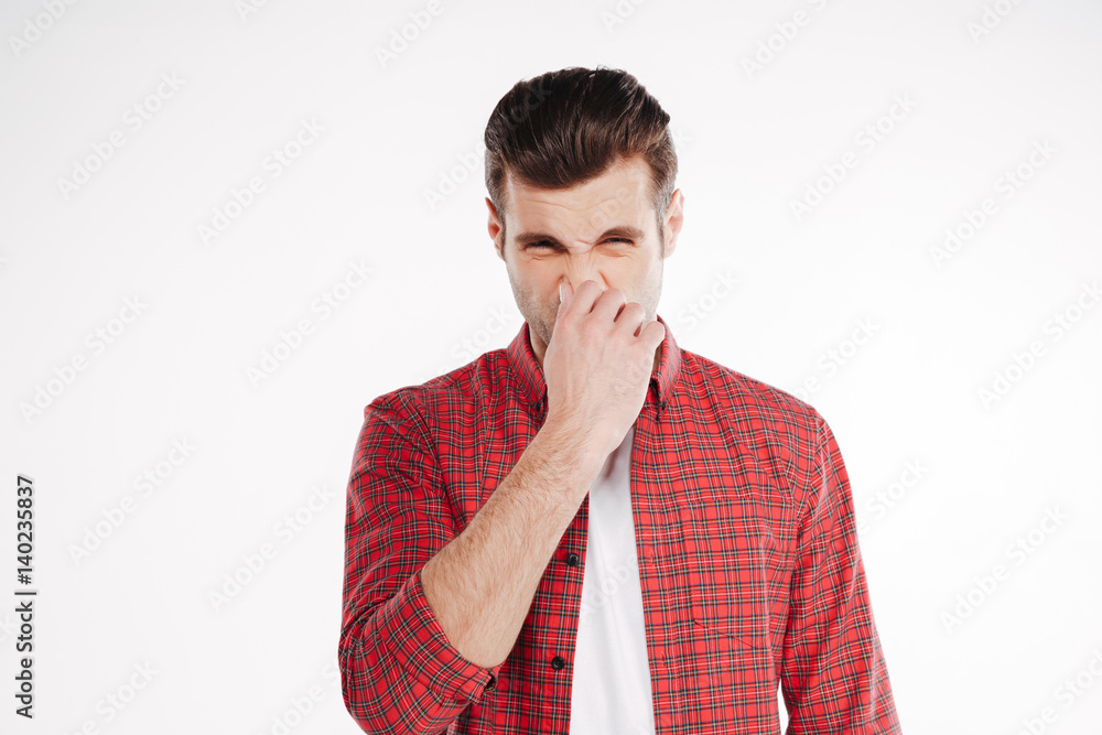 Man covering his nose