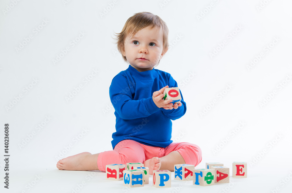 Little child playing with dices isolated on white background Little child playing with dices isolated on white background