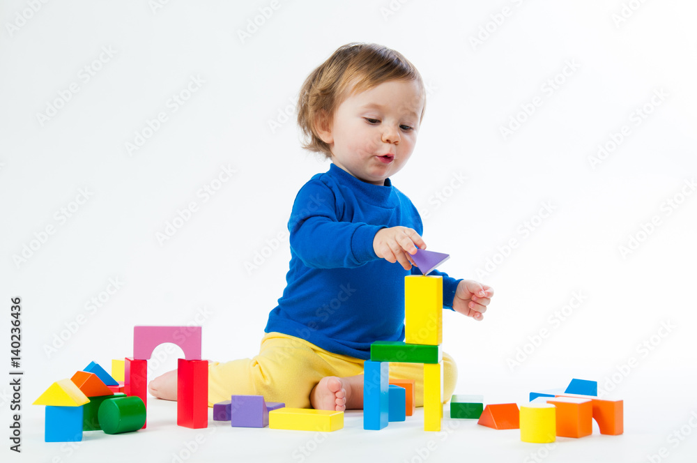 Little child playing with dices isolated on white background Little child playing with dices isolated on white background