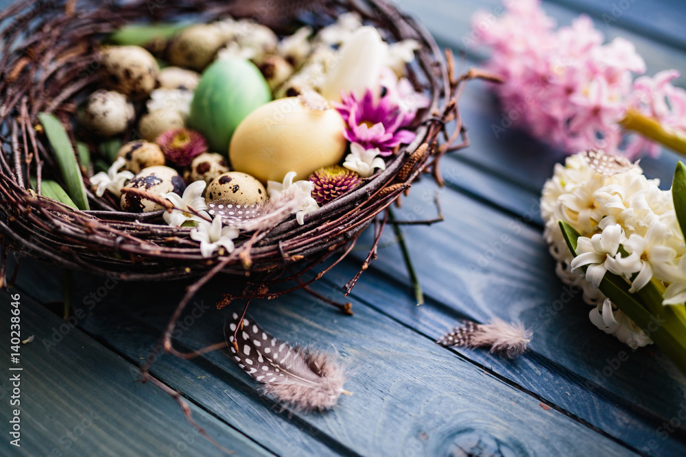 Nest with easter eggs on a blue wooden background Nest with easter eggs on a blue wooden background