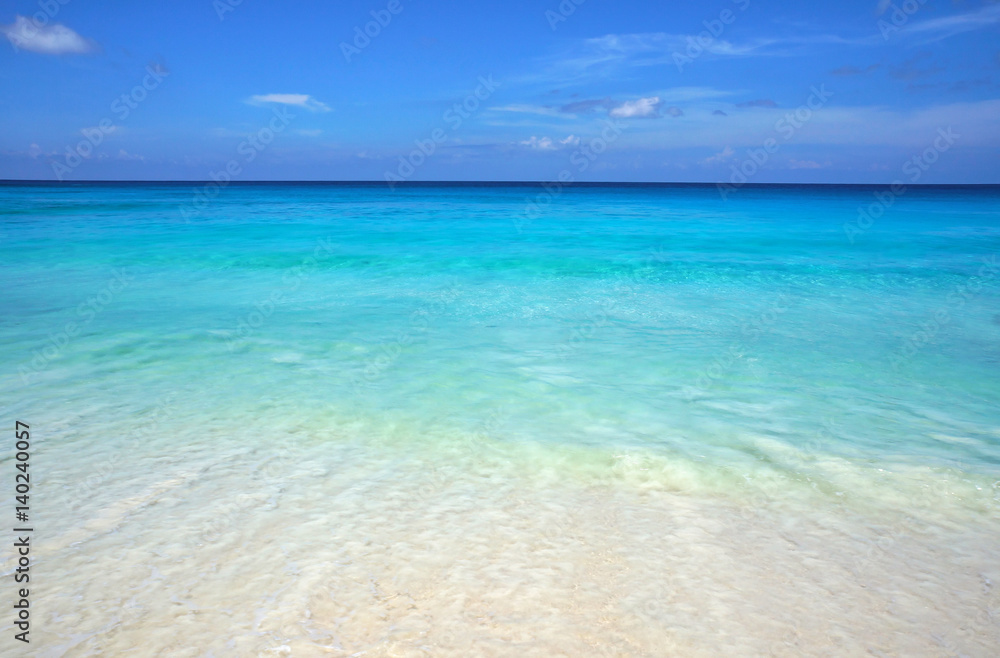 Scenic seascape of azure transparent ocean water and blue sky. Tropical beach with white sand. Idyllic scenery of seaside resort. Exotic travel destination for holiday and vacation