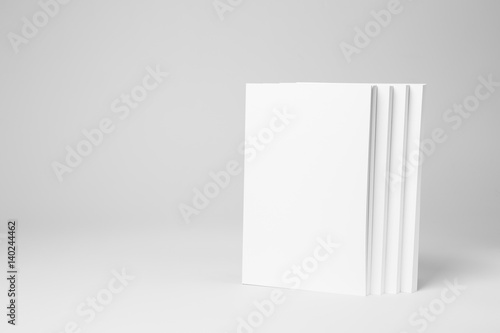 Real paperback white books on a gray background