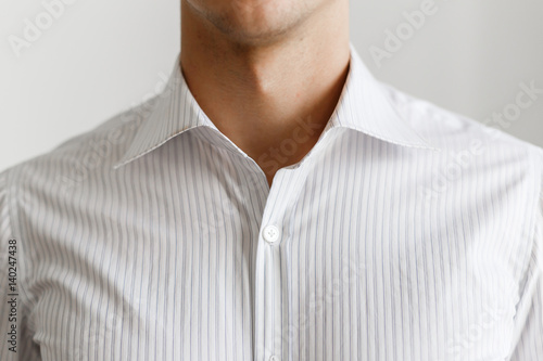 White shirt on the businessman. Unbuttoned collar. Beautiful elegant shirt. Close up view