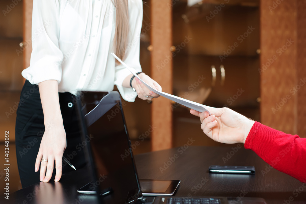 Hands of business people passing document