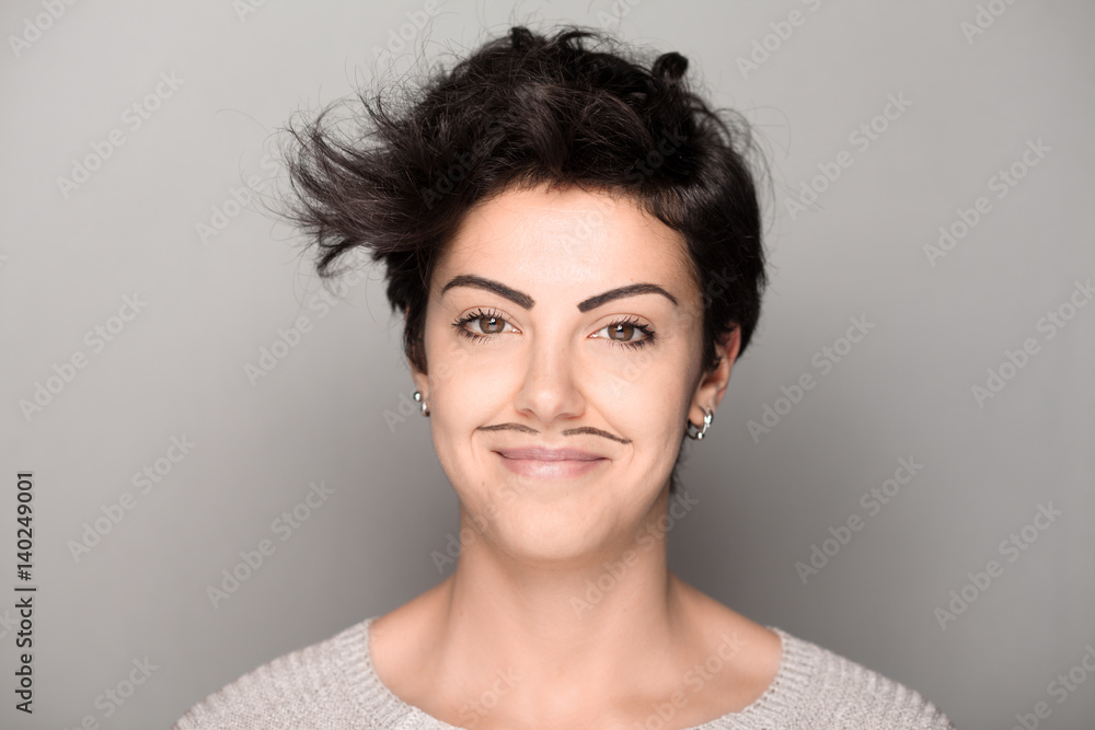 Smiling Woman with Drawn Mustaches on Gray Background Smiling Woman with Drawn Mustaches on Gray Background