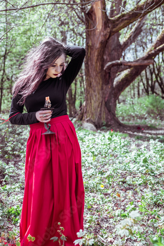 witch in the woods with a candle photo