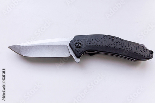 Pocket knife on a gray background. Top view. photo