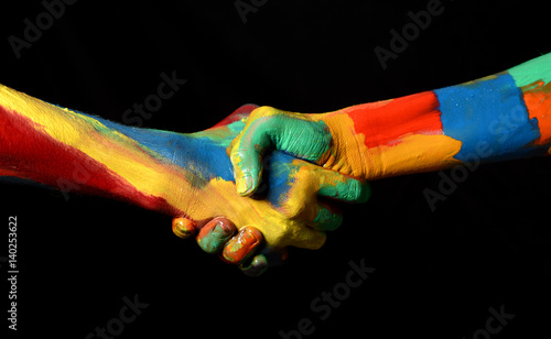 Photo Hand Shaking Gesture of Oil Painted Hands Diversity concept