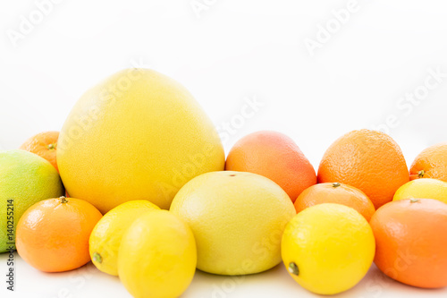 Fruit's background. Citrus fruits pattern made of lemon, orange, grapefruit, sweetie and pomelo on white background.