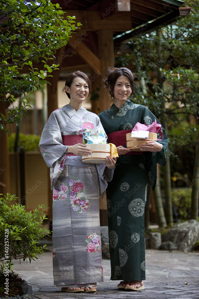 Women with containers standing outside the spa