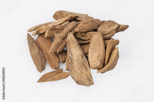Agarwood, also called aloeswood incense chips isolated on white photo