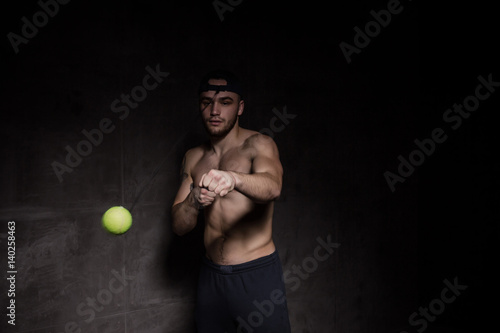 Boxer man training with fight ball photo