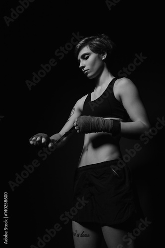 Woman wrapping hands with boxing wraps