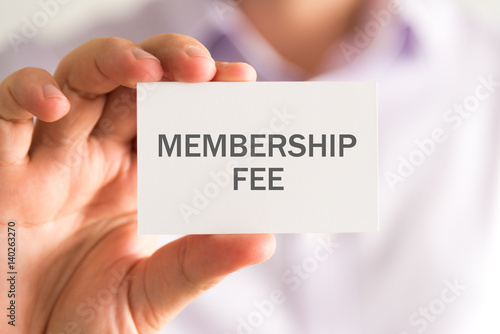 Businessman holding a card with MEMBERSHIP FEE message