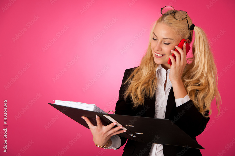 Business woman holding a folder and speaking on phone Business woman holding a folder and speaking on phone