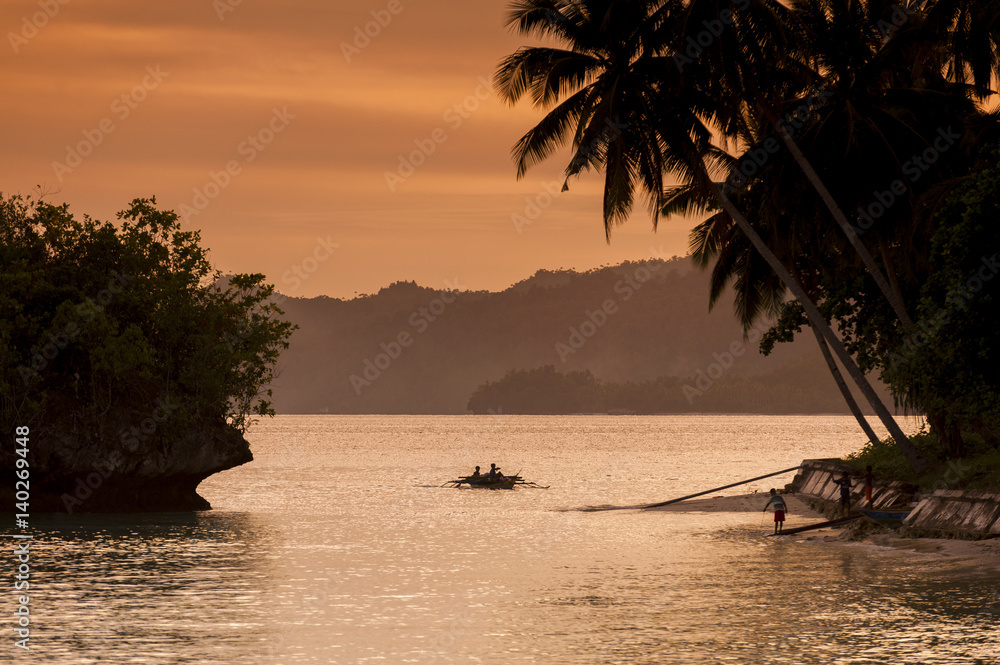 Naklejka premium Waigeo Island Indonesian Sunset. A colorful sunset in the Saporkren Village in the Raja Ampat area of West Papua, Indonesia.