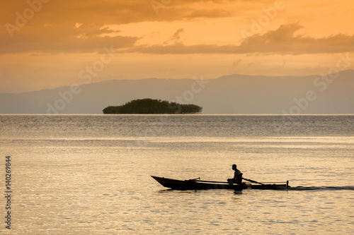 Raja Ampat, Indonesia. A lone fishermen heads out for an evening of fishing in the West Papua area near the village of Saporkren.
