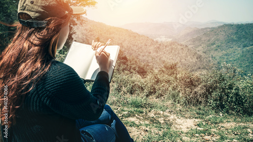 Women write notes Nature trails, mountains, forests. Writer