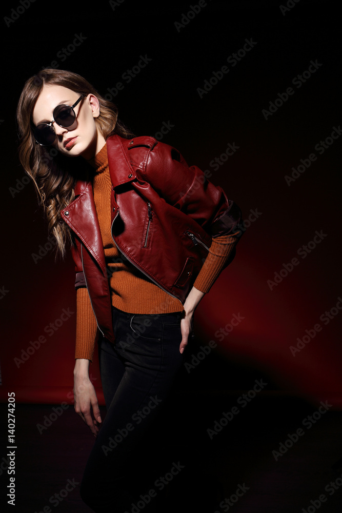 fashion model in sunglasses, beautiful young woman. leather jacket, studio shot fashion model in sunglasses, beautiful young woman. leather jacket, studio shot