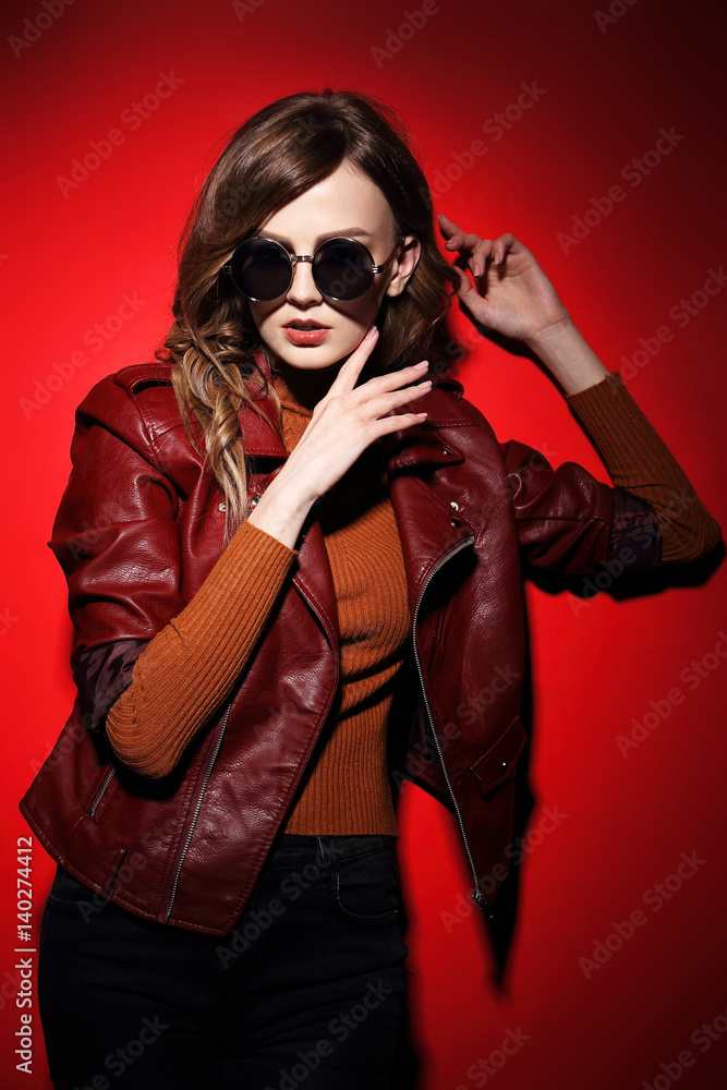 fashion model in sunglasses, beautiful young woman. leather jacket, studio shot fashion model in sunglasses, beautiful young woman. leather jacket, studio shot
