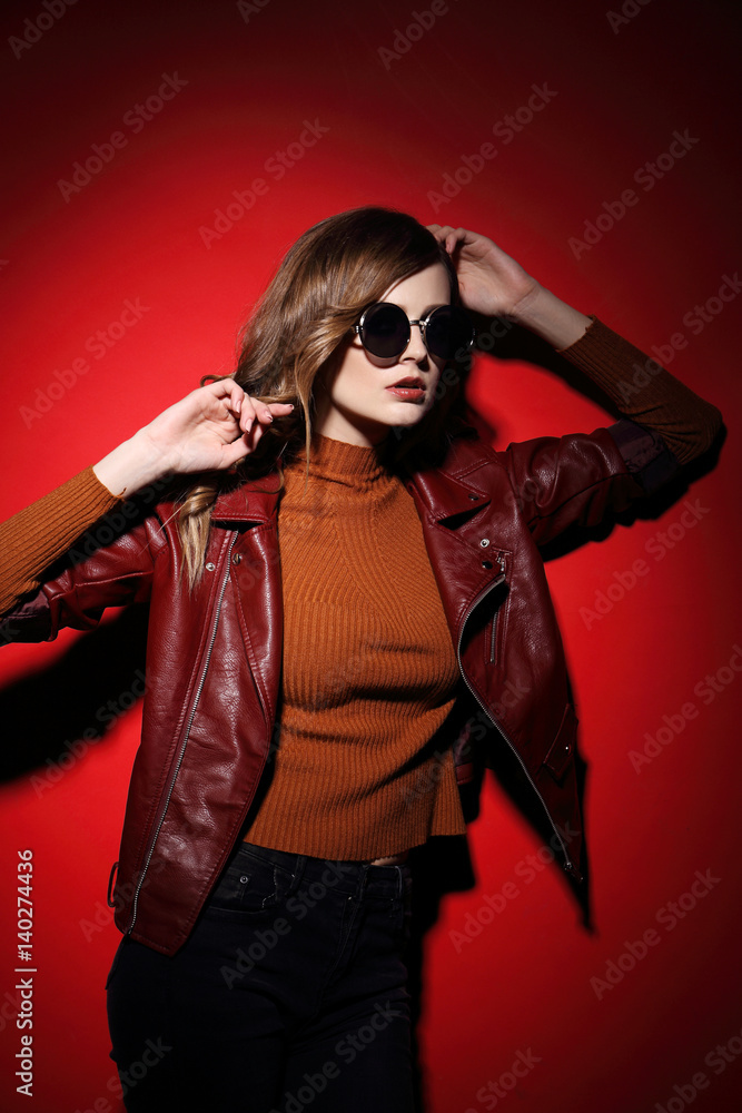 fashion model in sunglasses, beautiful young woman. leather jacket, studio shot fashion model in sunglasses, beautiful young woman. leather jacket, studio shot