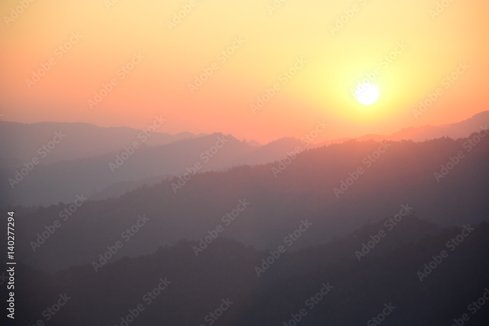 Blurred sunset silhouette  mountain landscape background with orange sky.